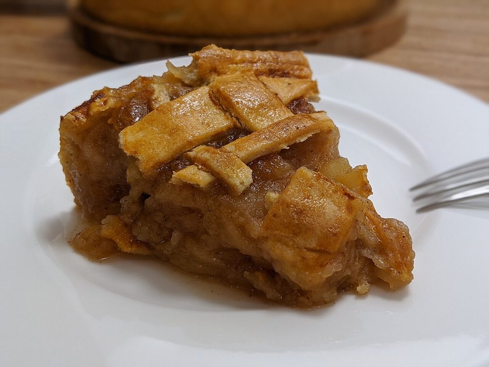 Stück Apple Pie mit Gitterdecke auf einem Teller